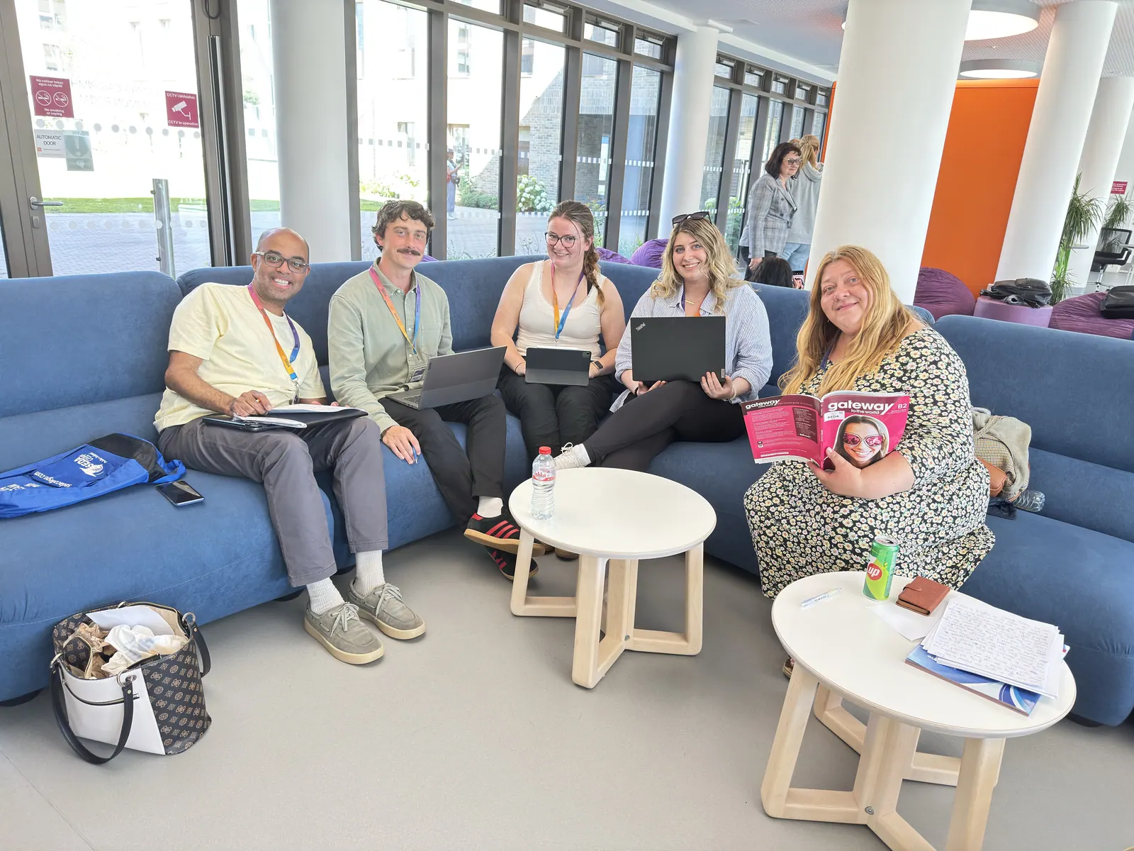 Adult learners seated together with study materials in a lounge